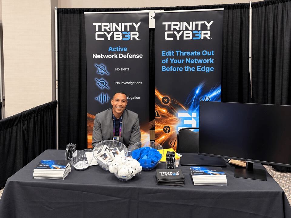 A team member at the Trinity Cyber conference booth