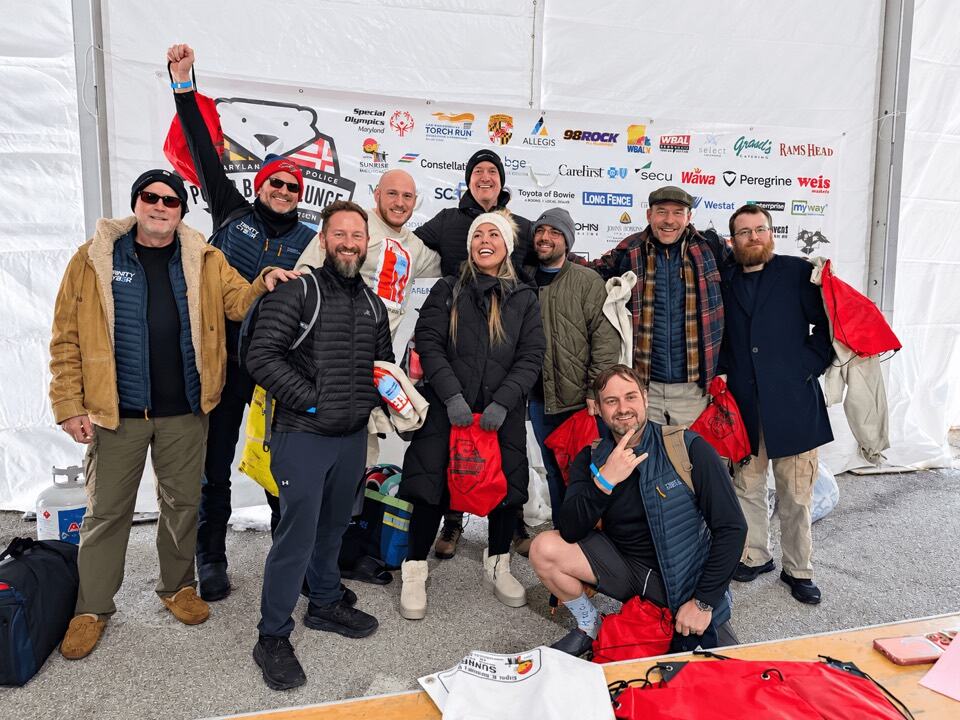 The team together outdoors at a community event